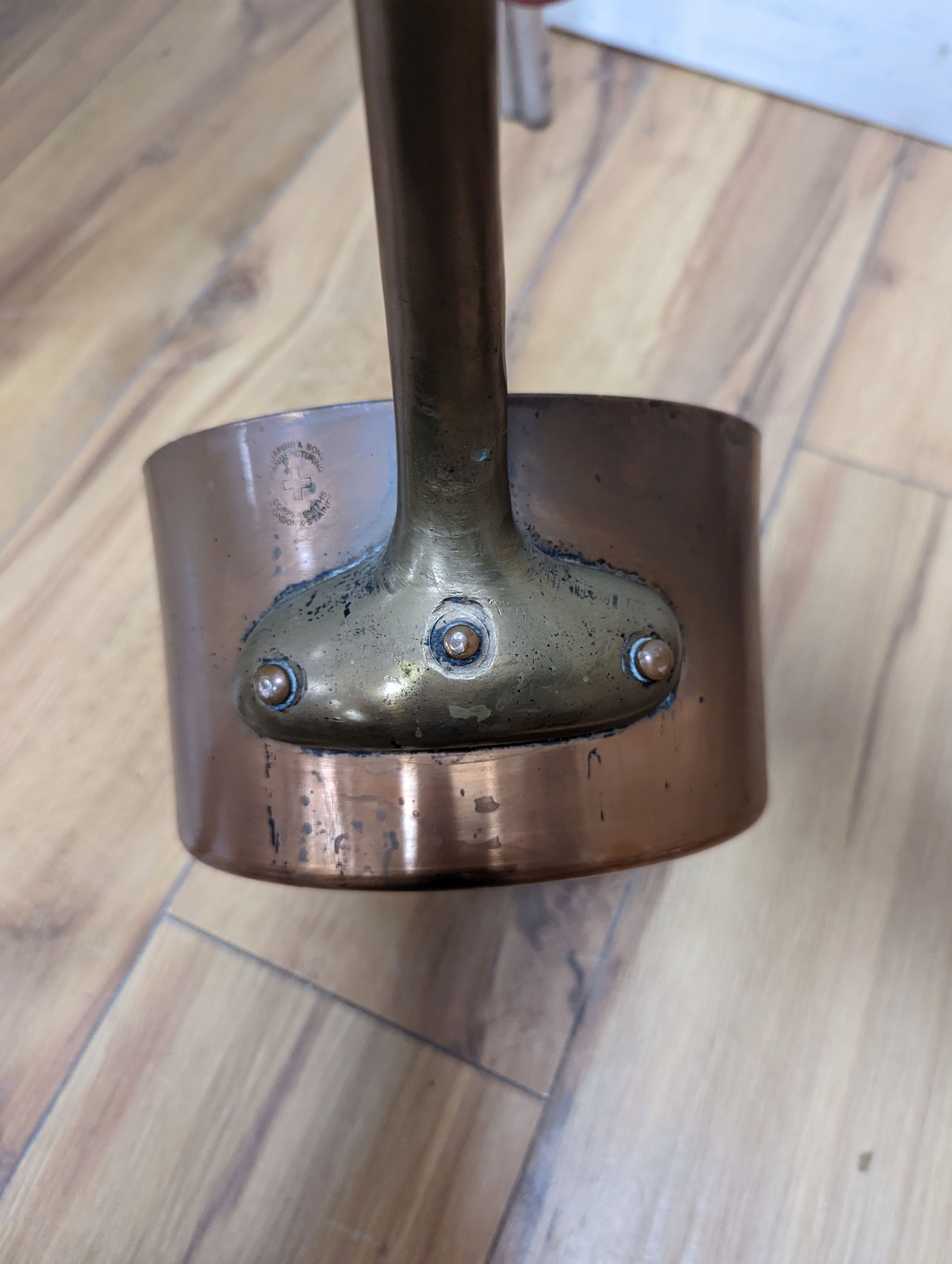 A group of three Jaeggi & Sons copper saucepans